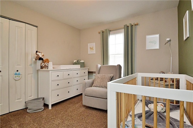 bedroom with a nursery area, carpet, and a closet