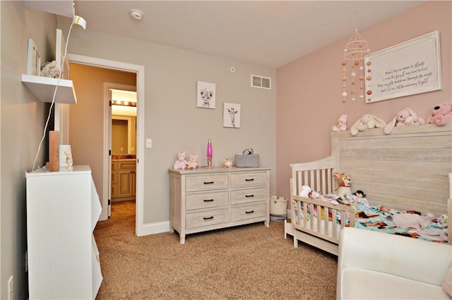 bedroom featuring a crib, baseboards, visible vents, and light colored carpet