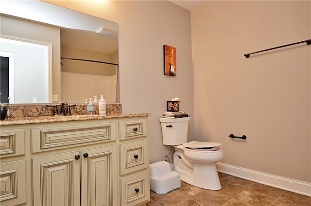 bathroom featuring baseboards, a shower, toilet, tile patterned floors, and vanity