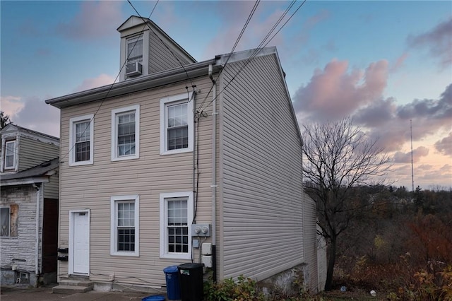 rear view of property with entry steps and cooling unit