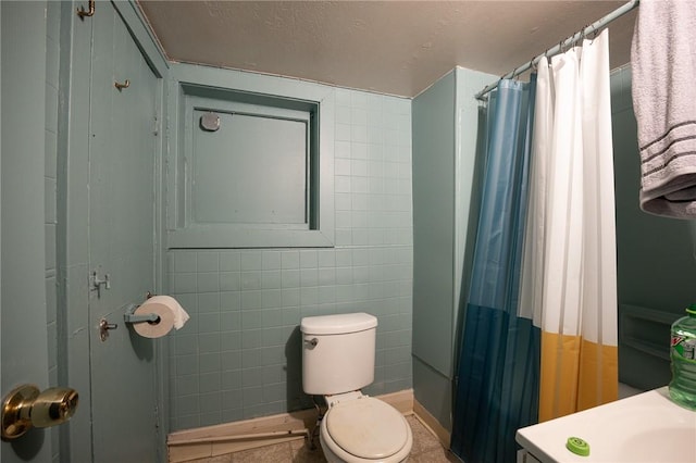 full bath featuring a shower with shower curtain, tile walls, and toilet