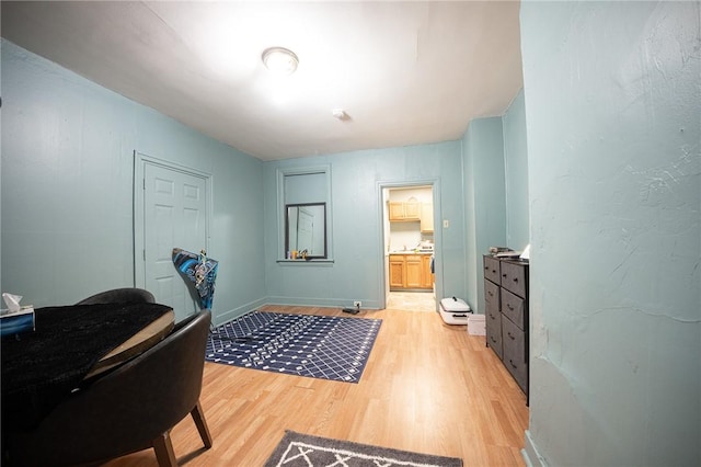 interior space with baseboards and light wood finished floors