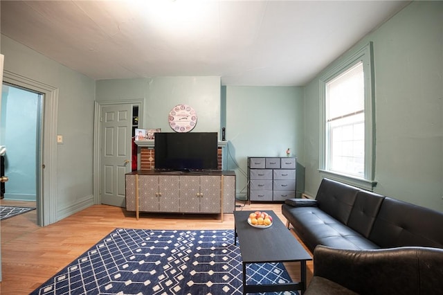 living room with baseboards and wood finished floors