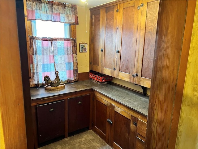 kitchen with dark countertops and brown cabinetry