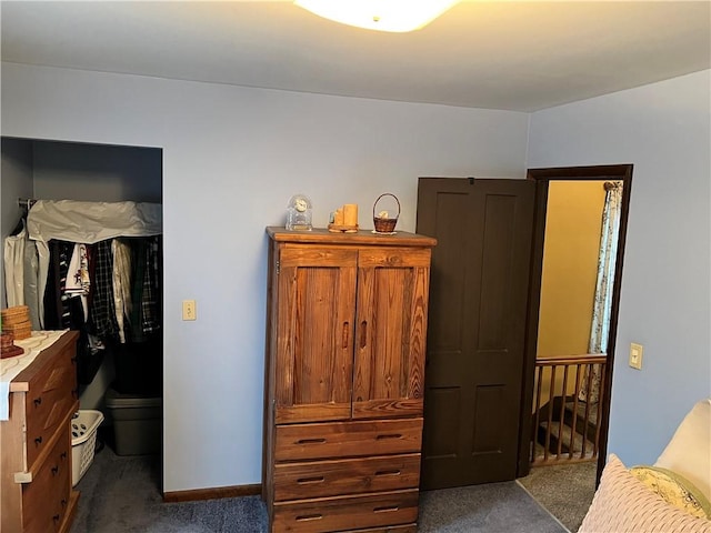 bedroom featuring dark carpet and baseboards