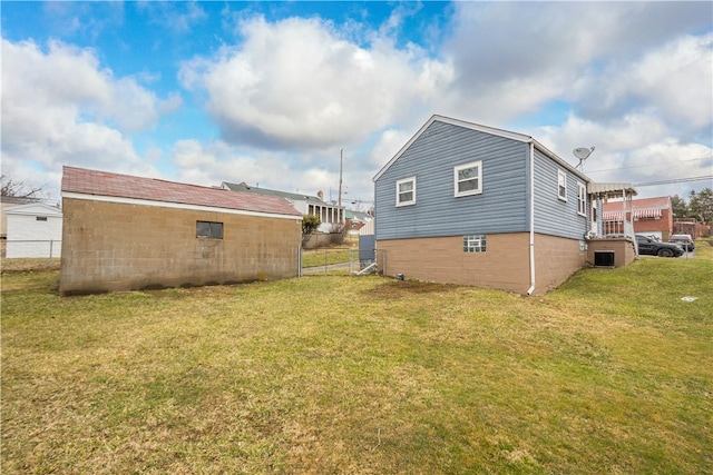 rear view of house featuring cooling unit, fence, and a lawn