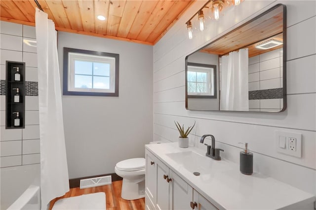 full bathroom featuring wooden ceiling, toilet, wood finished floors, vanity, and visible vents