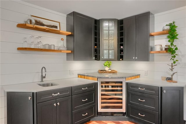 bar featuring beverage cooler, wet bar, and a sink