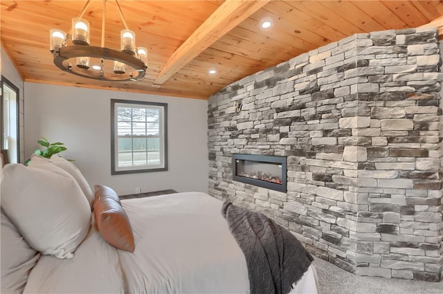 bedroom featuring a chandelier, a stone fireplace, wood ceiling, beamed ceiling, and carpet