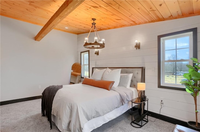 bedroom with wood ceiling, carpet flooring, beamed ceiling, and baseboards