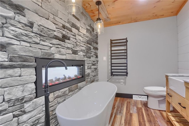 bathroom with visible vents, wood ceiling, radiator heating unit, wood finished floors, and a freestanding bath