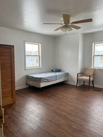 bedroom featuring dark wood-style floors, baseboards, and a ceiling fan