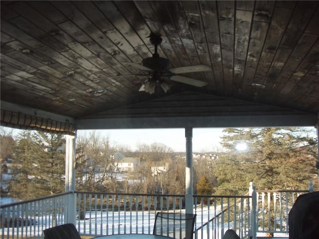 deck featuring a ceiling fan and a fenced in pool