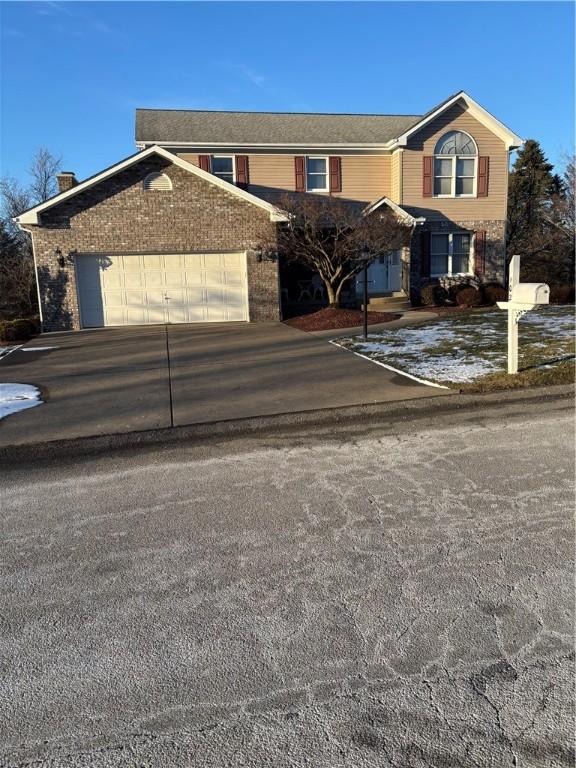 traditional-style home with a garage and driveway