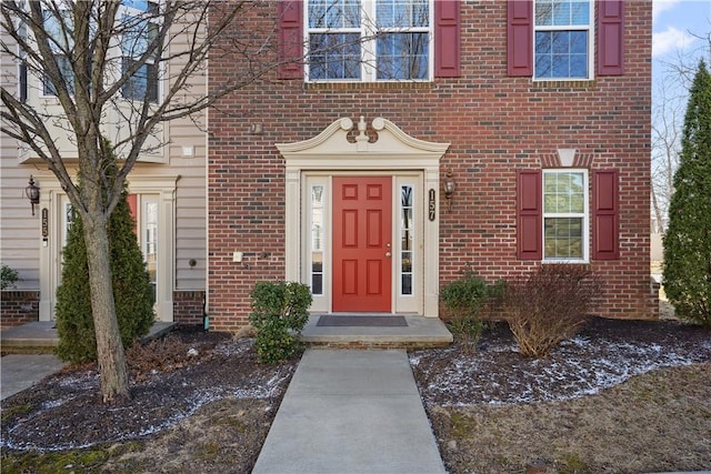 entrance to property featuring brick siding