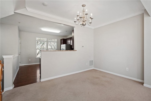 empty room featuring dark colored carpet, visible vents, and baseboards