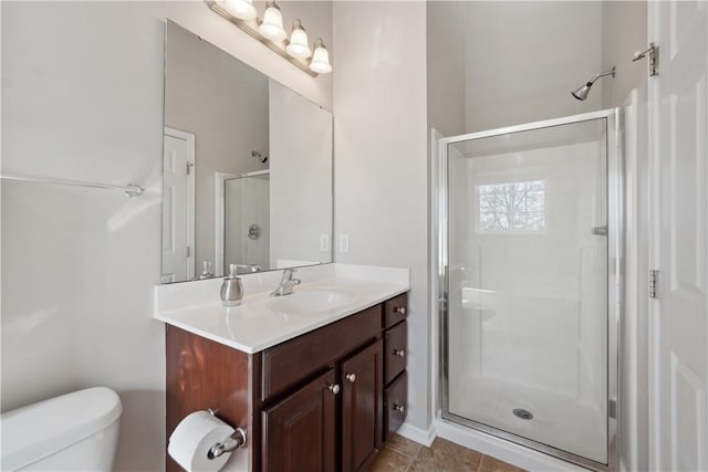 full bath with tile patterned floors, a shower stall, toilet, and vanity