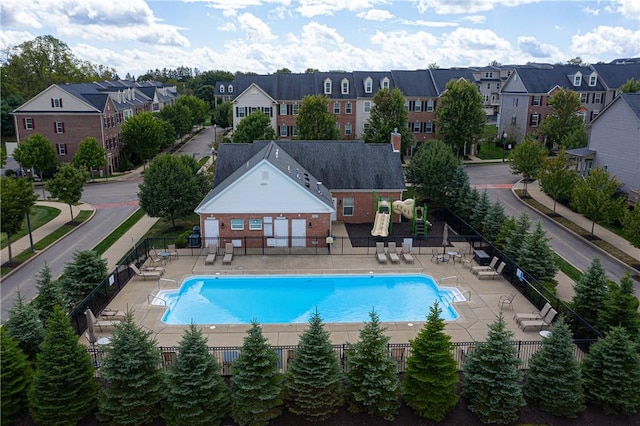 pool featuring a patio area, a residential view, and fence