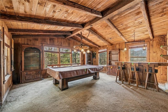 rec room with lofted ceiling with beams, wood walls, carpet flooring, wood ceiling, and a dry bar