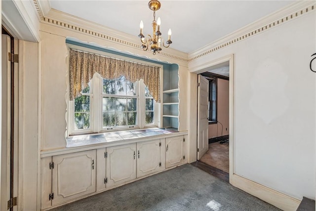 unfurnished dining area featuring crown molding, dark colored carpet, and a notable chandelier