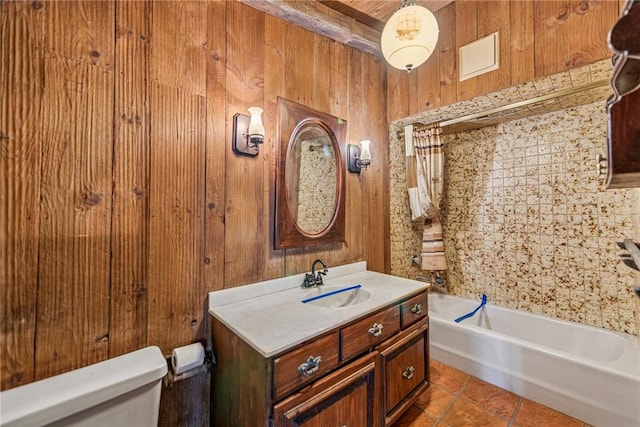 full bath with toilet, shower / tub combo with curtain, tile patterned floors, vanity, and wood walls