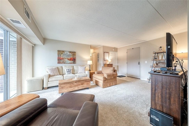 living room featuring a textured ceiling, visible vents, and light colored carpet