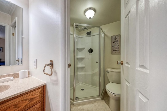 bathroom with a stall shower, vanity, and toilet