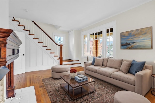 living room featuring hardwood / wood-style flooring and stairs