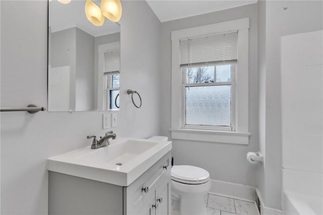 bathroom featuring a wealth of natural light, marble finish floor, vanity, and baseboards