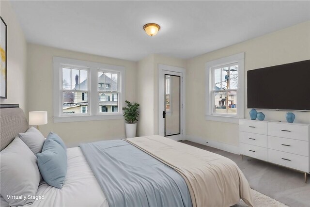 carpeted bedroom with baseboards