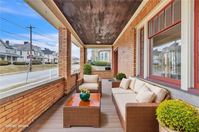 exterior space featuring a residential view, covered porch, and outdoor lounge area