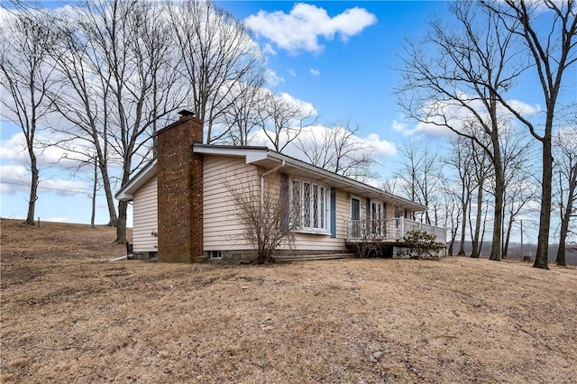 165 Mcelroy Rd, Sugarcreek Twp, PA 16028 - view of side of home with a chimney and a wooden deck