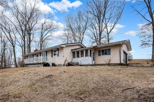 165 Mcelroy Rd, Sugarcreek Twp, PA 16028 - view of front of property with a sunroom, a chimney, and a wooden deck