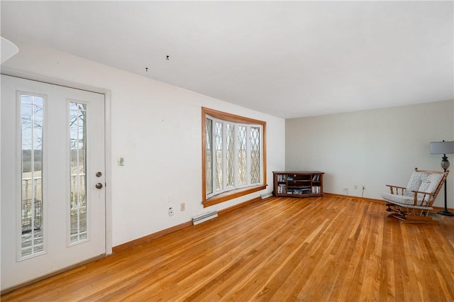 foyer featuring baseboards, visible vents, and light wood finished floors