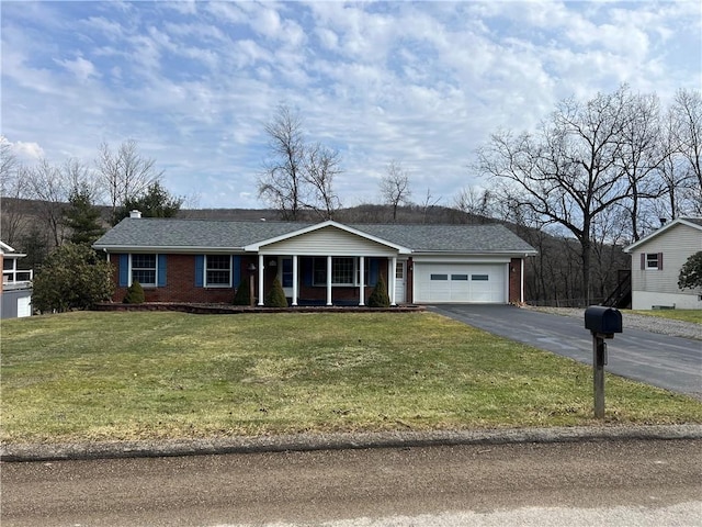 ranch-style house with a garage, a shingled roof, aphalt driveway, a front lawn, and brick siding