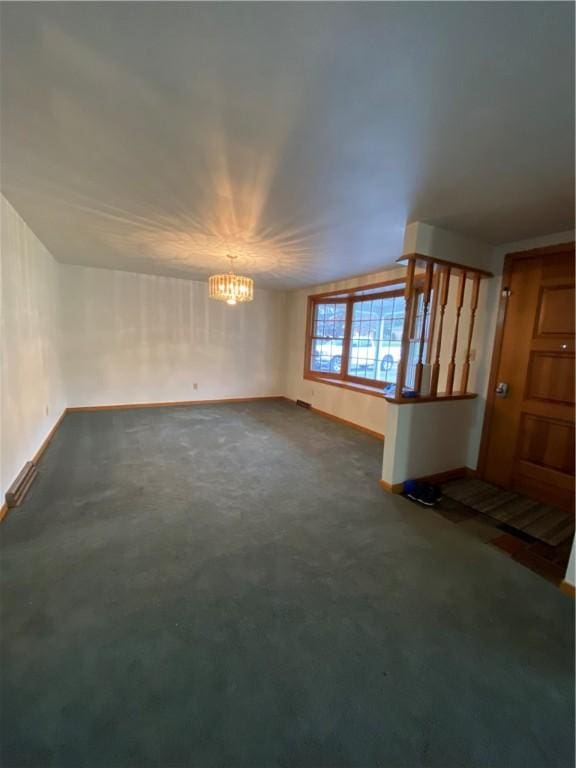 unfurnished living room with baseboards, dark carpet, vaulted ceiling, and a notable chandelier