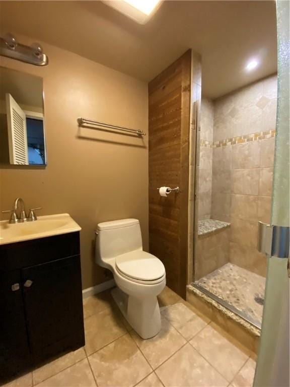 full bath featuring a stall shower, vanity, toilet, and tile patterned floors