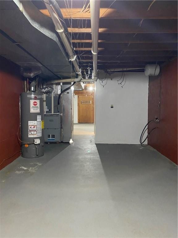 unfinished basement with gas water heater and heating unit