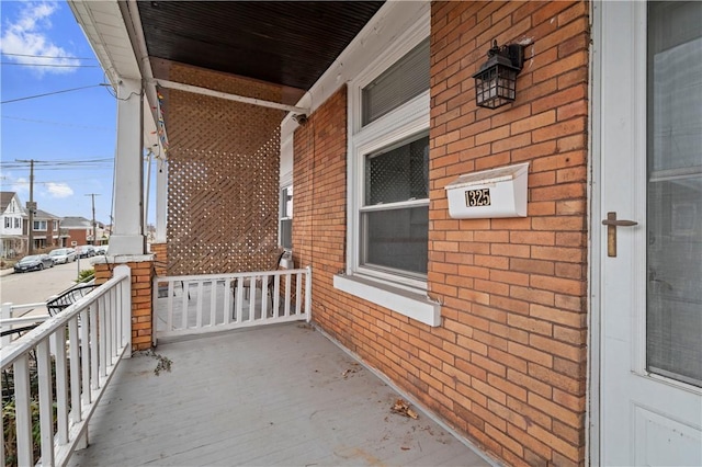 balcony featuring covered porch and a residential view