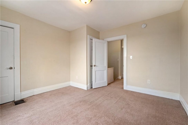 unfurnished bedroom with carpet and baseboards