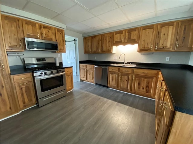 12 Little Pine Pl, City Of Franklin, PA 16323 - kitchen with a sink, appliances with stainless steel finishes, dark countertops, brown cabinets, and a drop ceiling