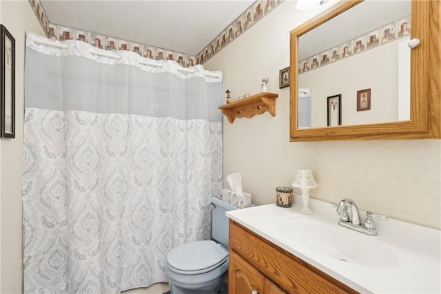 bathroom featuring toilet, curtained shower, and vanity