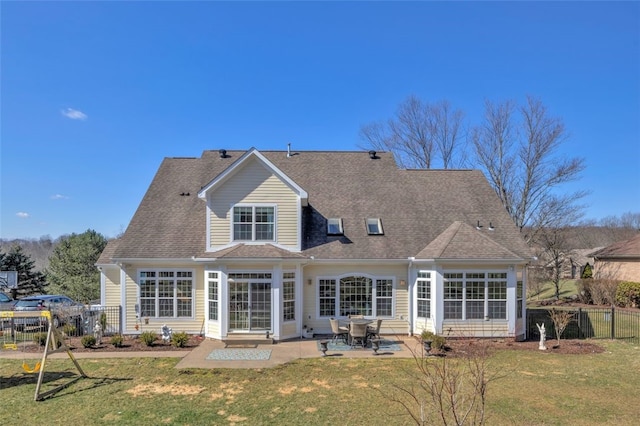 rear view of property featuring a yard, a patio area, fence, and a sunroom