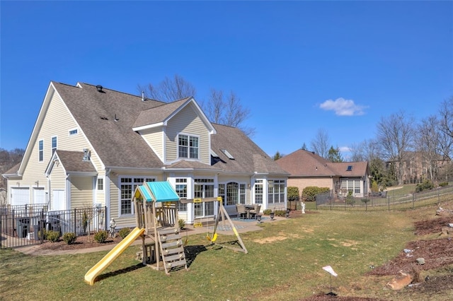 rear view of property with a patio area, roof with shingles, fence, and a yard