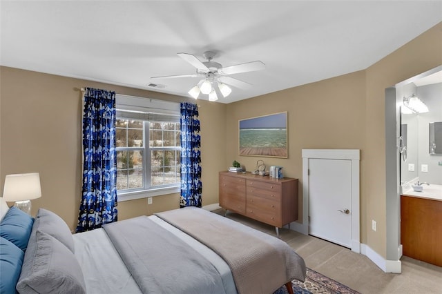 bedroom with light colored carpet, visible vents, a sink, ceiling fan, and baseboards