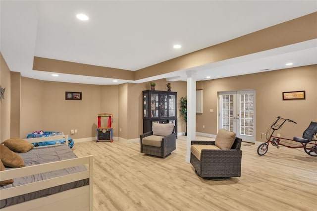 living room featuring light wood-type flooring, french doors, and recessed lighting