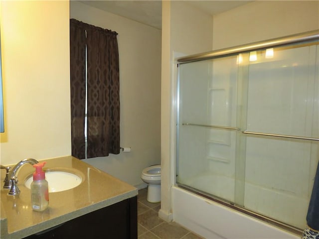 full bathroom with toilet, shower / bath combination with glass door, tile patterned flooring, and vanity