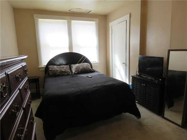 bedroom featuring light colored carpet