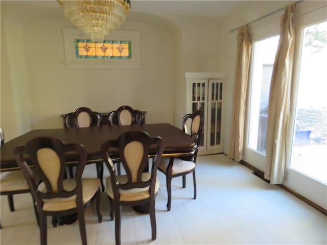 dining room with arched walkways and an inviting chandelier