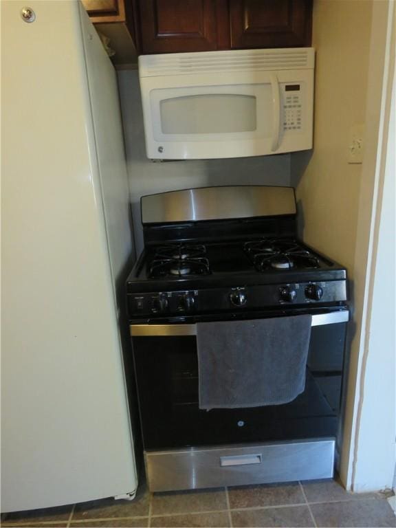 kitchen with white appliances and tile patterned flooring